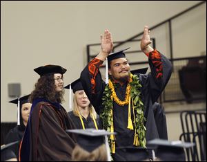 David ‘Chief’ Kekuewa wears his ‘puakenikeni’ and his ‘maile’ his parents brought to him from Hawaii as he graduates at Saturday’s commencement ceremonies at BGSU.