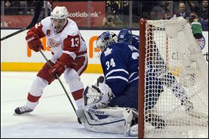 Detroit Red Wings' Pavel Datsyuk, left, scores on Toronto Maple Leafs goaltender James Reimer during a game in December.