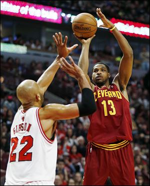 Cleveland Cavaliers forward Tristan Thompson, right, shoots over Chicago Bulls forward Taj Gibson. 