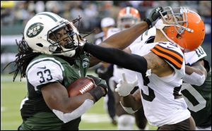 New York Jets running back Chris Ivory, left, stiff-arms Cleveland Browns cornerback Joe Haden during the second half Sunday in East Rutherford, N.J.