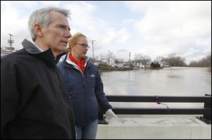 U.S. Sen. Rob Portman and Findlay Mayor Lydia Mihalik survey the flood scene. The mayor said Monday the river crested early that morning. 