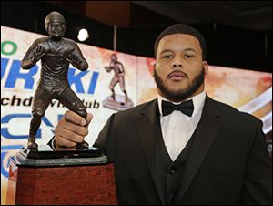 Pittsburgh's Aaron Donald poses with the Bronko Nagurski Trophy for the college football defensive player of the year.