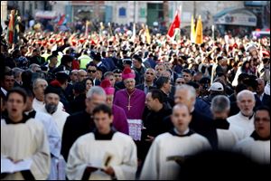 Latin Patriarch of Jerusalem Fouad Twal, center, arrives to the Church of the Nativity, traditionally believed by Christians to be the birthplace of Jesus Christ.