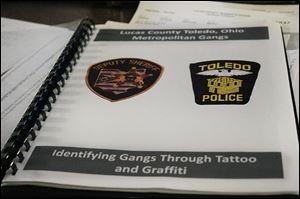 The Lucas County jail gang identifying folder is used by officials to distinguish gang markings.