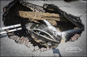 Pamela Knox was southbound on North Detroit Avenue near West Bancroft Street on July 3 when the road caved in underneath her. City officials said 19th century sanitary and storm sewers collapsed.