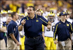 Michigan coach Brady Hoke yells at officials during the first half of the Buffalo Wild Wings Bowl on Saturday night in Tempe, Ariz.