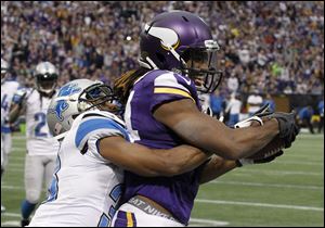 Minnesota Vikings wide receiver Cordarrelle Patterson, right, catches an eight-yard touchdown pass in front of Detroit Lions cornerback Chris Greenwood during the second half on Sunday in Minneapolis.
