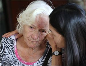 Thai caretaker, right, consoles Elizabeth, an Alzheimer patient from Switzerland, at Baan Kamlangchay care center in Chiang Mai province, northern Thailand.