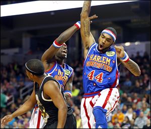 Globetrotter ‘The Shot’ leaps into the air after making a bucket in the game at the Huntington Center.