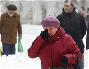 A Volgograd resident walks crying in Volgograd, Russia early today. A bomb blast tore through a trolleybus in the city of Volgograd early today, killing at least 10 people a day after a suicide bombing that killed at least 17 at the city's main railway station.