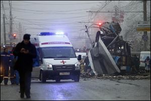 Experts, firefighters and police officers examine a site of a trolleybus explosion in Volgograd, Russia today.