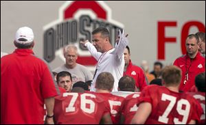 Ohio State coach Urban Meyer talks to his team during Tuesday’s practice in Davie, Fla.  The yards and points could pile up during an Orange Bowl featuring two of the nation’s most potent offenses.