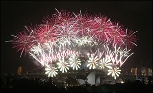 Fireworks explode over the Harbour Bridge and the Opera House during New Year's Eve celebrations in Sydney, Australia.