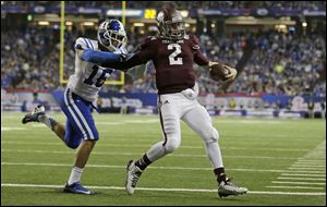 Texas A&M quarterback Johnny Manziel (2) scores a touchdown as Duke safety Jeremy Cash (16) defends in the second half.