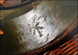 The fallen enemy soldier etched a palm tree and his name on the underside of his helmet, which Toledoan John Wast found and carried home from the war. 