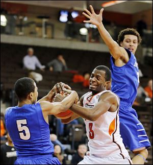 Bowling Green’s Spencer Parker battles Indiana University-Purdue University Fort Wayne’s Mo Evans, left, in Thursday’s game at the Stroh Center. Parker finished with 15 points for the Falcons.