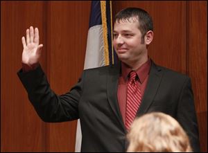 Matt Cherry waves to the audience after he's sworn in as a new city councilman during the first Toledo City Council meeting of the year at One Government Center, today.