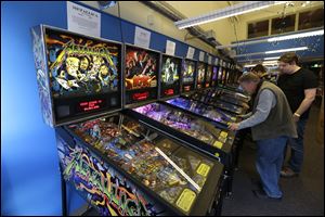 Visitors play pinball on more modern machines at the Seattle Pinball Museum in Seattle.