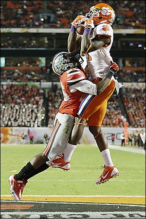 Clemson Tigers wide receiver Martavis Bryant makes a catch for a touchdown as Ohio State cornerback Armani Reeves arrives too late.