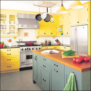 Paint your kitchen workhorse an accent color. This dark green balances walls lined with warm-yellow cabinets and creates a strong visual impact.