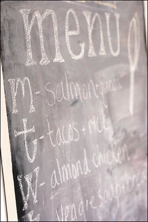 A wall painted with chalkboard paint can used as a menu.