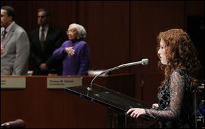 Notre Dame Academy junior April Varner sings the National Anthem during the first City Council meeting of the year on Thursday at One Government Center.