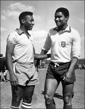 Brazilian footballer Edson Arantes do Nascimento, known as Pele, left, enjoys a chat with Eusebio da Silva Ferreira in Lisbon, Portugal in this 1963 file photo.