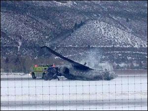 Emergency crews respond as a small plane lies on a runway at Aspen Airport in western Colorado after it crashed upon landing Sunday.