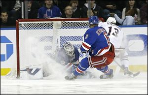 Columbus Blue Jackets' Cam Atkinson (13) scores on New York Rangers goalie Henrik Lundqvist (30) during the second period Monday in New York.