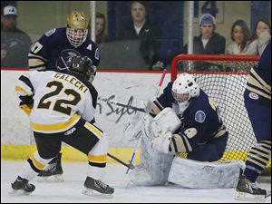 St. John’s goaltender Mike Barrett stops a shot by Northview’s Zack Galecki. Barrett is 8-2-2 with four shutouts and a 1.14 goals-against average. The Titans are 12-2-2, 3-0-1 in the NHC Red Division.