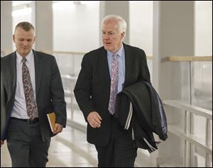 Senate Minority Whip John Cornyn, R-Texas, walks to the Senate through an underground tunnel on the way to a scheduled procedural vote in the Senate on a bill that would extend unemployment benefits, at the Capitol in Washington, Monday.