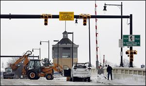 Toledo crews remove snow from the Martin Luther King, Jr., Bridge, which should be helped by a warming pattern in the next few days, according to the National Weather Service. Temperatures may reach into the 40s. 