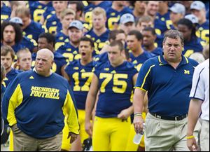 Michigan offensive coordinator Al Borges, left, was relieved of his services. UM averaged 373.5 yards per game, 10th in the Big Ten.