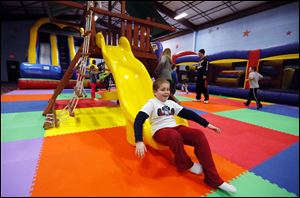 Connor Radkov, 9, slides to the bottom on Sylvania Playland gym equipment on Centennial Road. The third grader was enjoying another day off from Stranahan Elementary School.