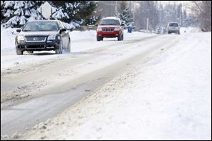 Monroe County motorists, such as these on West Sterns Road near Lewis Avenue, were hampered by snow and ice pack that remained for a fourth day on primary and secondary travel routes.  