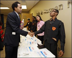David Johns, left, leader of the White House Initiative on Educational Excellence for African-Americans, speaks with Sierra Stelter, a Woodward High School junior, and Day’Shawn Jones, a Woodward senior.