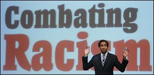 David Johns, left, Executive Director, White House Initiative on Academic Excellence for African Americans, speaks during the Toledo Community Coalition's public forum on combating racism at the University of Toledo, Thursday, Jan. 9, 2014.