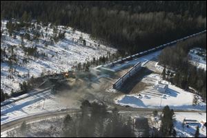 This aerial photo shows derailed train cars burning in Plaster Rock, New Brunswick Wednesday.