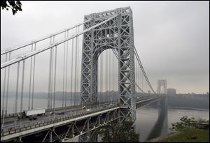 Traffic moves across the George Washington Bridge in Fort Lee, N.J.. A top aide to New Jersey Gov. Chris Christie is linked through emails and text messages to a seemingly deliberate plan to create traffic gridlock in a town at the base of the bridge after its mayor refused to endorse Christie for re-election. 