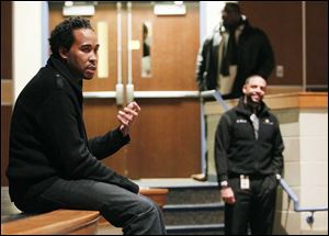 David Johns, executive director of the White House Initiative on Educational Excellence for African-Americans, talks to Woodward High students as Romules Durant, superintendent of Toledo Public Schools, looks on at right.  Mr. Johns spoke Friday at the school.