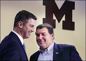 Doug Nussmeier, left, and Michigan coach Brady Hoke are all smiles Friday after Nussmeier was introduced as the Wolverines’ new offensive coordinator.