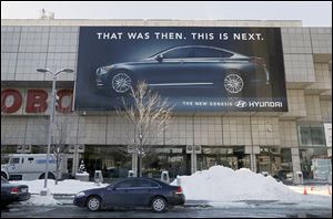 A Hyundai Genesis banner is displayed outside Cobo Center, home of the North American International Auto Show, in downtown Detroit. More than 500 vehicles are expected to be on display.