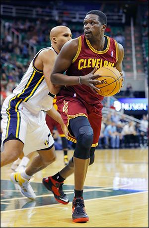Cleveland Cavaliers newcomer Luol Deng, right, works for a shot against Utah’s Richard Jefferson. He had 10 points and four turnovers in his first game with the team.