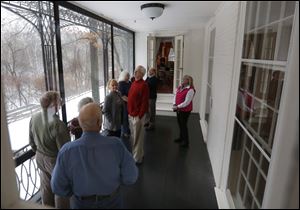 Volunteer guide Deanne Douglas, right, shows off one of the balconies during the Behind the Scenes of Stranleigh tour at the Manor House at Wildwood Preserve in Toledo, on Saturday, Jan. 11, 2014.