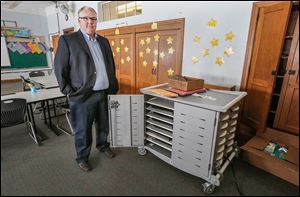 Northwood Superintendent Greg Clark shows a laptop storage unit at Northwood Elementary. Janitors must unplug computers when vacuuming so no fuses are blown; the room has 20 amps of service. 