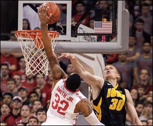Ohio State’s Lenzelle Smith, Jr., tries to dunk the ball over Iowa’s Aaron White. Smith finished the game with 10 points.