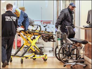 Toledo Fire and Rescue personnel bring a patient to the University of Toledo Medical Center emergency room, which cared for 37,000 patients in 2011. A new study suggests ERs will get even busier in the coming years.