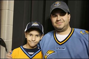 Anthony, 10, left, and his father Gary Stiff, of West Toledo attended the game. Gary Stiff was declared the team's millionth fan since the beginning of the 2009 season.