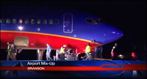 This frame grab provided by KSPR-TV shows a Southwest Airlines flight that was scheduled to arrive Sunday at Branson Airport in southwest Missouri instead landed at an airport 7 miles north — with a runway about half the size of the intended destination. 