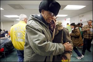 John Whitlow, outreach technician, left, hugs former client Velma Trotter, right, while he was visiting St. Paul’s Community Center.